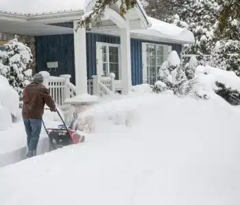 Man using snowblower in deep snow